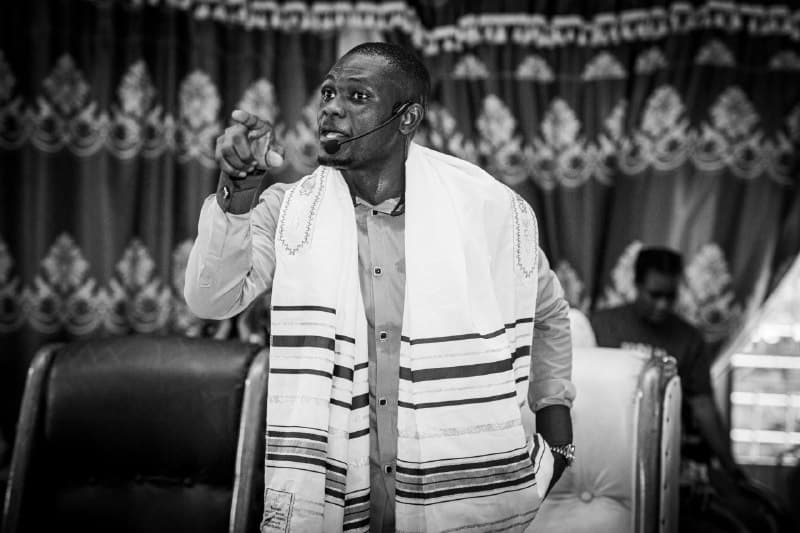 A preacher teaching and pointing toward the congregation