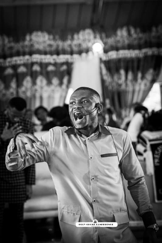 A minister speaking passionately during the Holy Ghost Conference