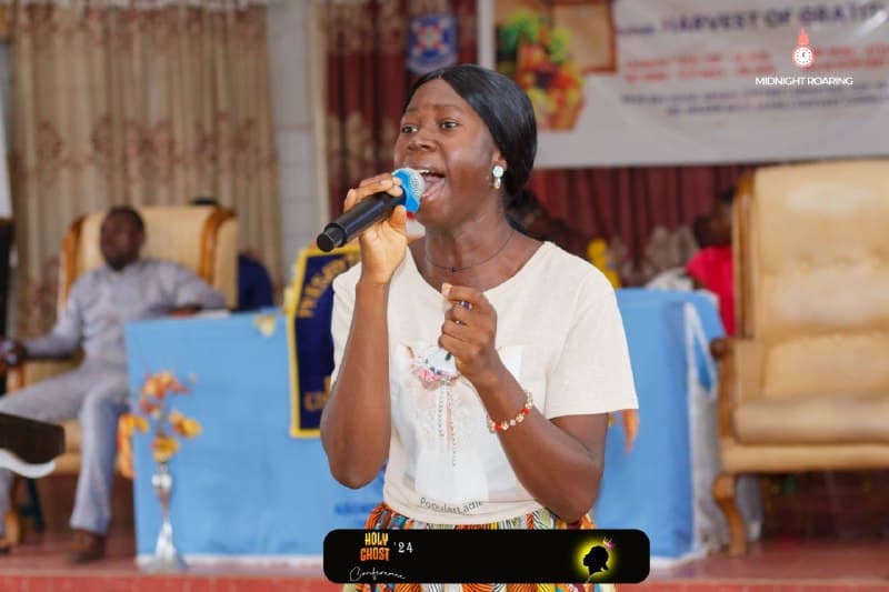 A worship leader singing during the Holy Ghost Conference